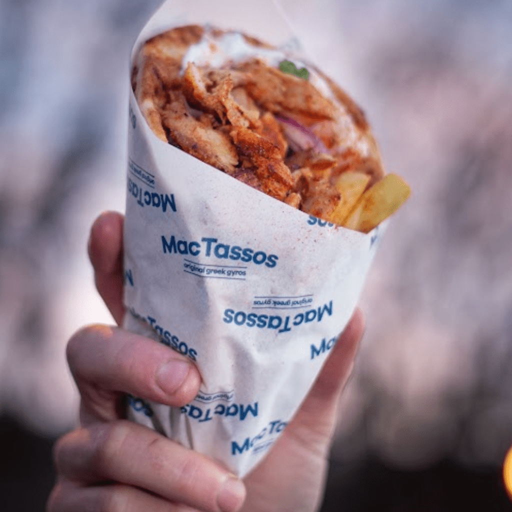 Fresh chicken gyros wrap with tzatziki, salad and chips served in warm pita bread at MacTassos Silverburn.