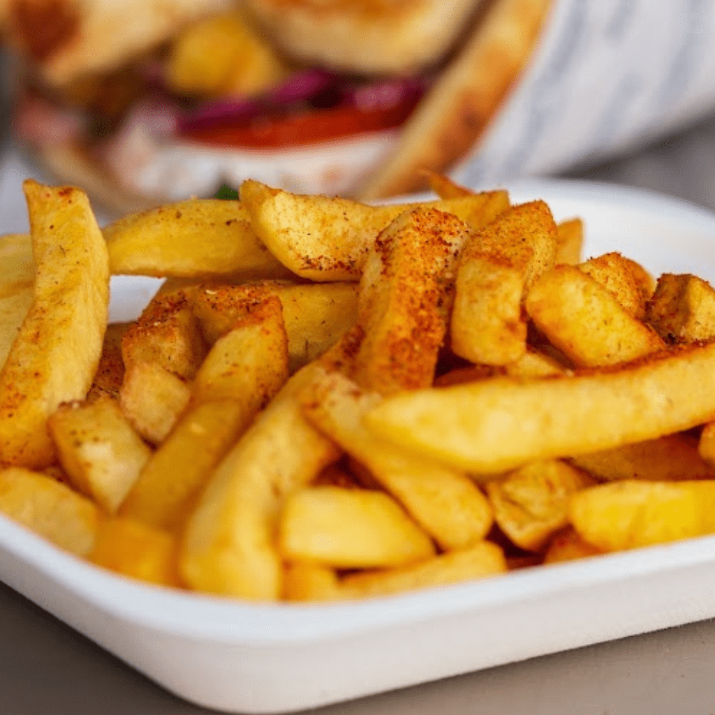 Golden crispy chips served fresh as a side with MacTassos gyros and Greek street food.