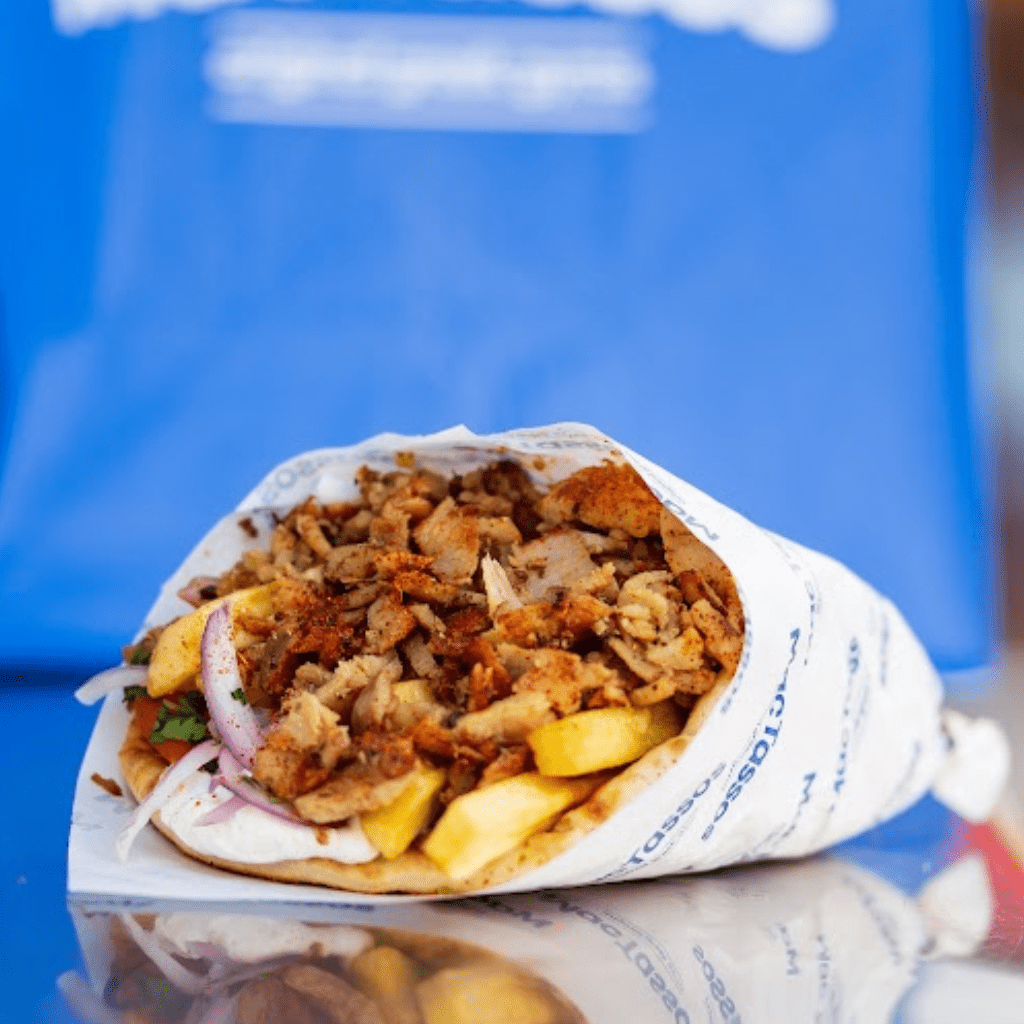Authentic Greek pork gyros wrap with tzatziki, tomato, onion, parsley and chips at MacTassos Silverburn.