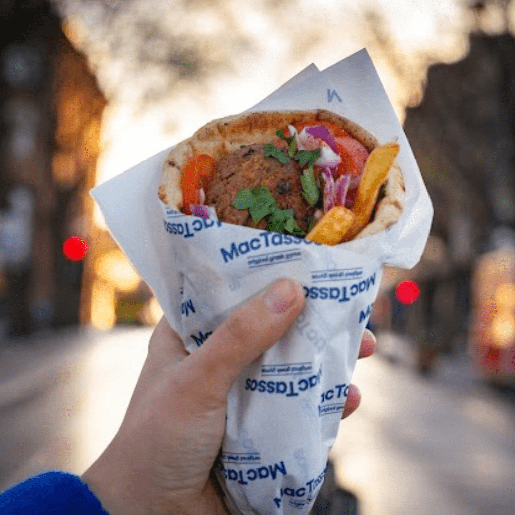 Crispy falafel gyros wrap with tzatziki, fresh salad and chips served in Greek pita bread.