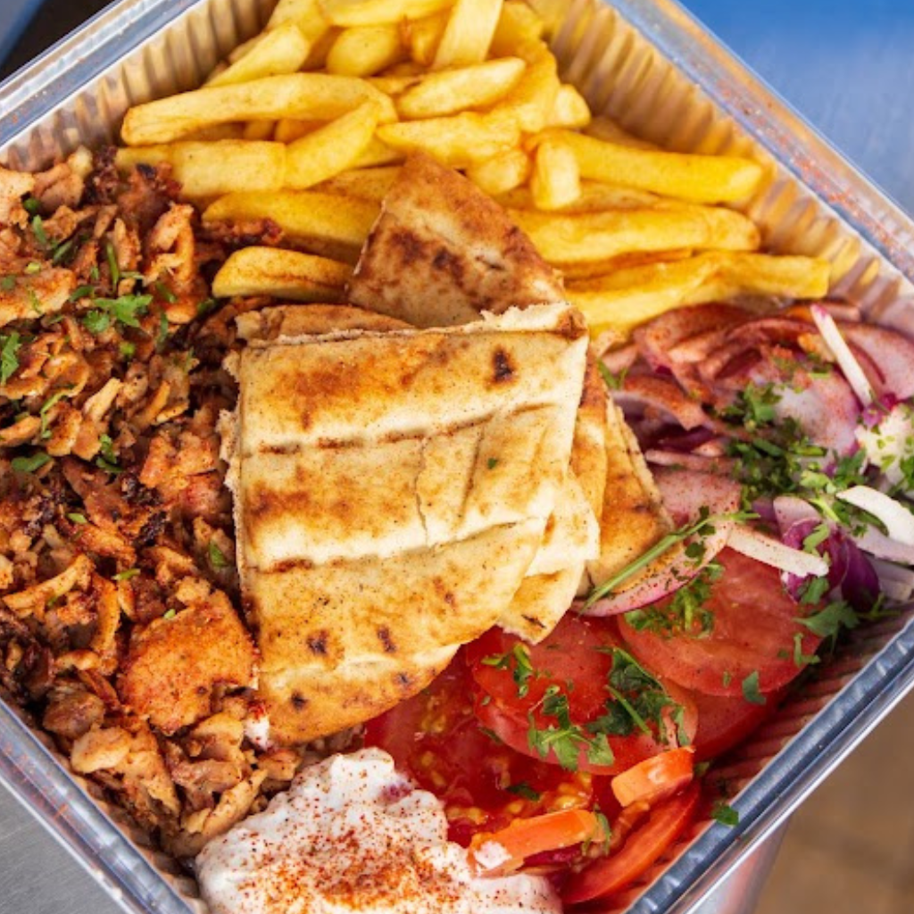 Mixed chicken and pork gyros plate served with chips, salad, pita bread and tzatziki.